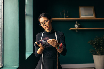 Woman tailor choosing the best fabric