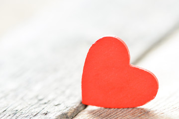 Fototapeta premium Heart on a wooden background. Background in the style of Valentine's Day. Heart on a wooden background.