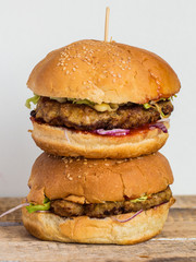 Burger with chop, cheese, onion and tomato sauce