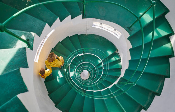 Overhead view of mother and son on spiral staircase, Tavares, Rio Grande do Sul, Brazil, South America