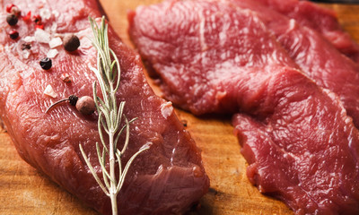 Raw beef filet mignon on wooden board