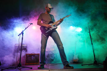 The guitarist performs on stage.