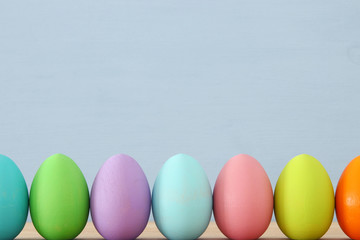 Top view of easter colorful eggs over blue background.
