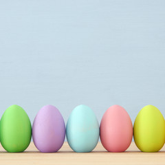 Top view of easter colorful eggs over blue background.