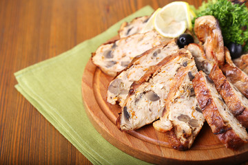 Chicken stuffed on wooden board. Tasty dinner