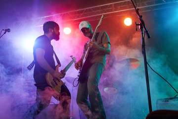Fototapeta premium Guitarist and bass player perform on stage.