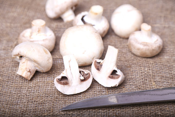 Champignon mushrooms and a knife