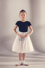 The little balerina dancer on gray background © master1305