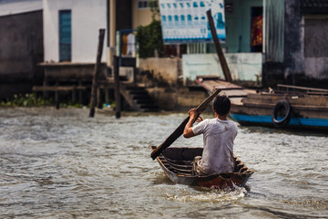 Man rowing a rudimentary boat
