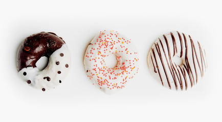 Top view of tasty colorful doughnuts isolated over white background. 