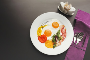 Restaurant breakfast with bacon and fried eggs