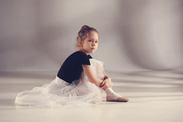 The little balerina dancer on gray background © master1305