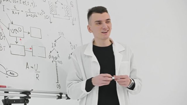 Teacher explaining arithmetic formula and equation and asking children on lesson