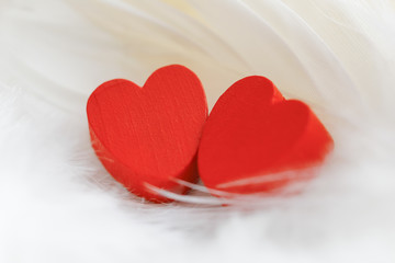 Red wooden heart with white background.