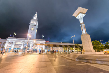 SAN FRANCISCO - AUGUST 7, 2017: Tourists along Embarcadero at night. The city attracts 20 million people annually