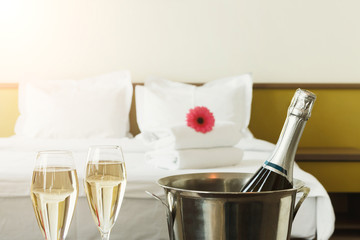 Two glasses and bottle of champagne in hotel