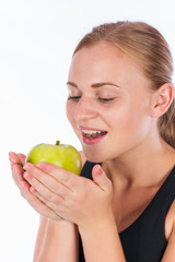 Young smiling girl with a green apple in her hand