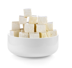 tofu in a bowl on white background