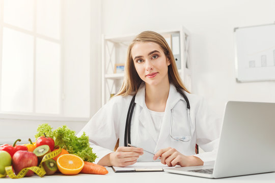Female nutritionist working on laptop