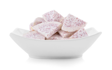slice taro root in a bowl on white background