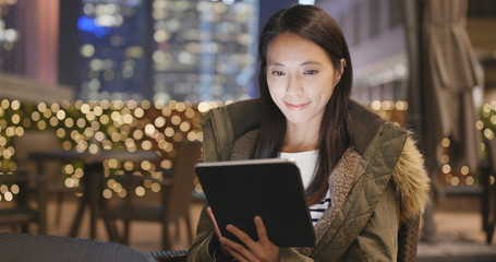 Woman use of digital tablet computer in city coffee shop