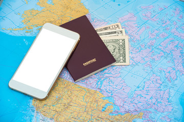 Fototapeta na wymiar Passport and smart phone with blank and dollars on a world map background