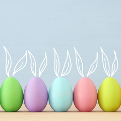 Top view of easter colorful eggs over blue background.