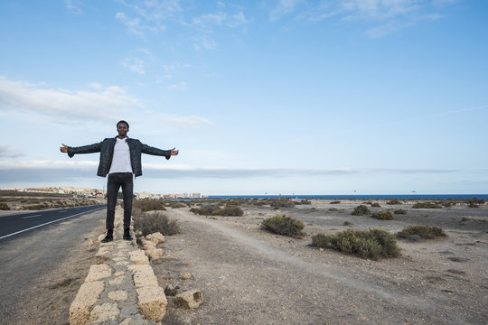 Spain, Tenerife, young man standing on wall
