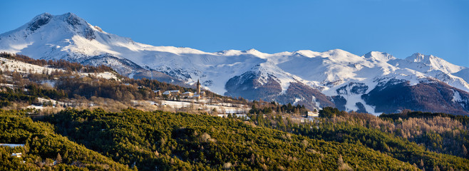 Winter panoramic view of the Saint-Sauveur village and the Les Orres sky resort in the background. Hautes-Alpes, French Alps, France