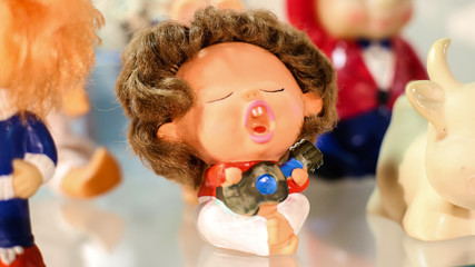 Toy boy singing with a guitar