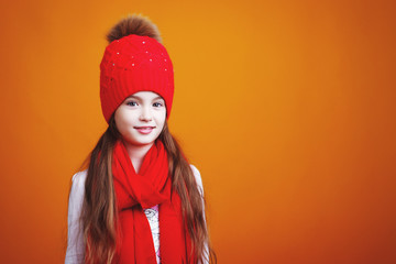 little girl in a red hat and scarf on a yellow background