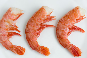 Three prawns on white plate. Shrimps. Healthy Seafood