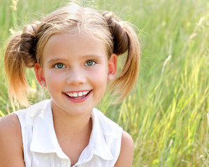 Portrait of adorable smiling little girl in summer day outdoor