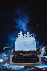 Fantasy writer workplace with a typewriter and paper castle. Fortress of an imagination. Creative...