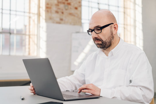 Unhappy businessman working on a laptop