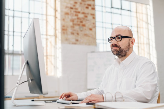 Businessman working on a large desktop monitor