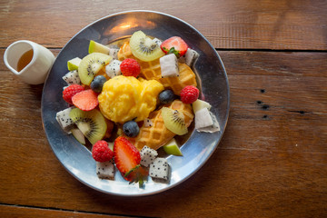 fresh healthy fruit salad on wooden background
