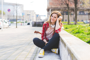 young woman sitting outdoor looking camera smiling - happiness, positive emotions, attitude concept