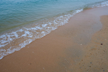 Wave of the sea on the sand beach.