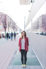 Young beautiful woman posing outdoor in the city - getting away from it all, city living, everyday life concept