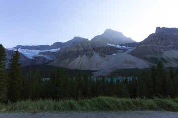 Empty road on Icefields Parkway in Rocky Mountains during sunset