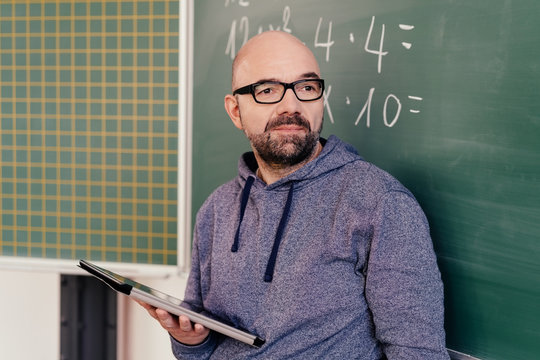 Maths teacher standing in front of a blackboard
