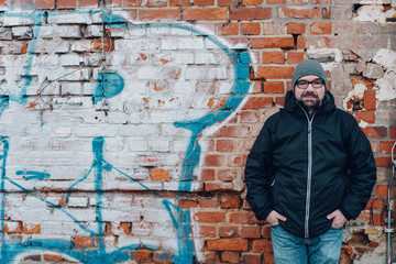 Trendy modern middle-aged man with graffiti