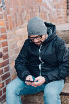 Middle-aged man using mobile phone for messages