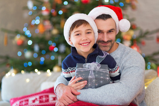 Father And Son At Christmas Time At Home

