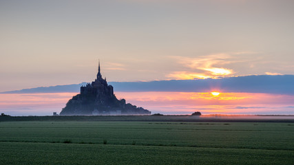 Obraz premium Beautiful panoramic view of famous Le Mont Saint-Michel tidal island at sunrise. Normandy, northern France