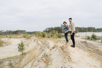 Two happy travelers with backpack walking on the forest in sunset. Casual fashion of tourism. Around Europe and Asia