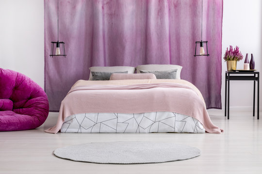 Pink coverlet on bed