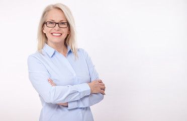 Middle aged business woman with eyeglasses in blue shirt isolated on white background