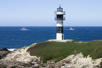 Fototapeta na wymiar Illa Pancha in Ribadeo, Spain, a beautiful island with two lighthouses guarding the Eo estuary that delimits the border between Galicia and Asturias
